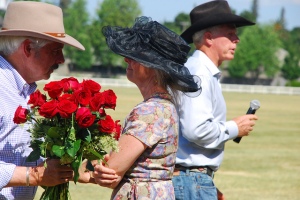 May 4, 2013. Winners of the calcutta, Jeff (left) and Kate (center) Haas accept congratulatory roses.